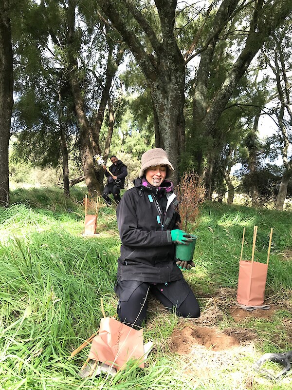 Keen volunteers Keeti-Moana Clarke and Shannon Fitzgerald helping get young plants in the ground. Photo: Jesse Bythell